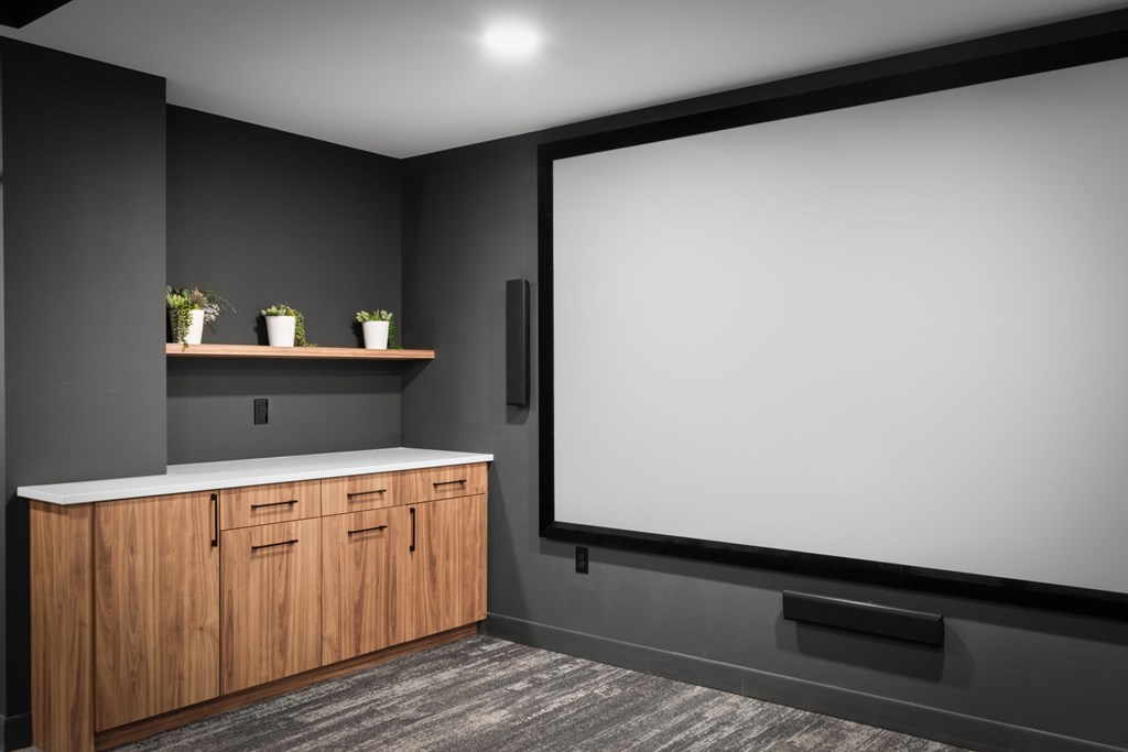 a room with a large screen on the wall